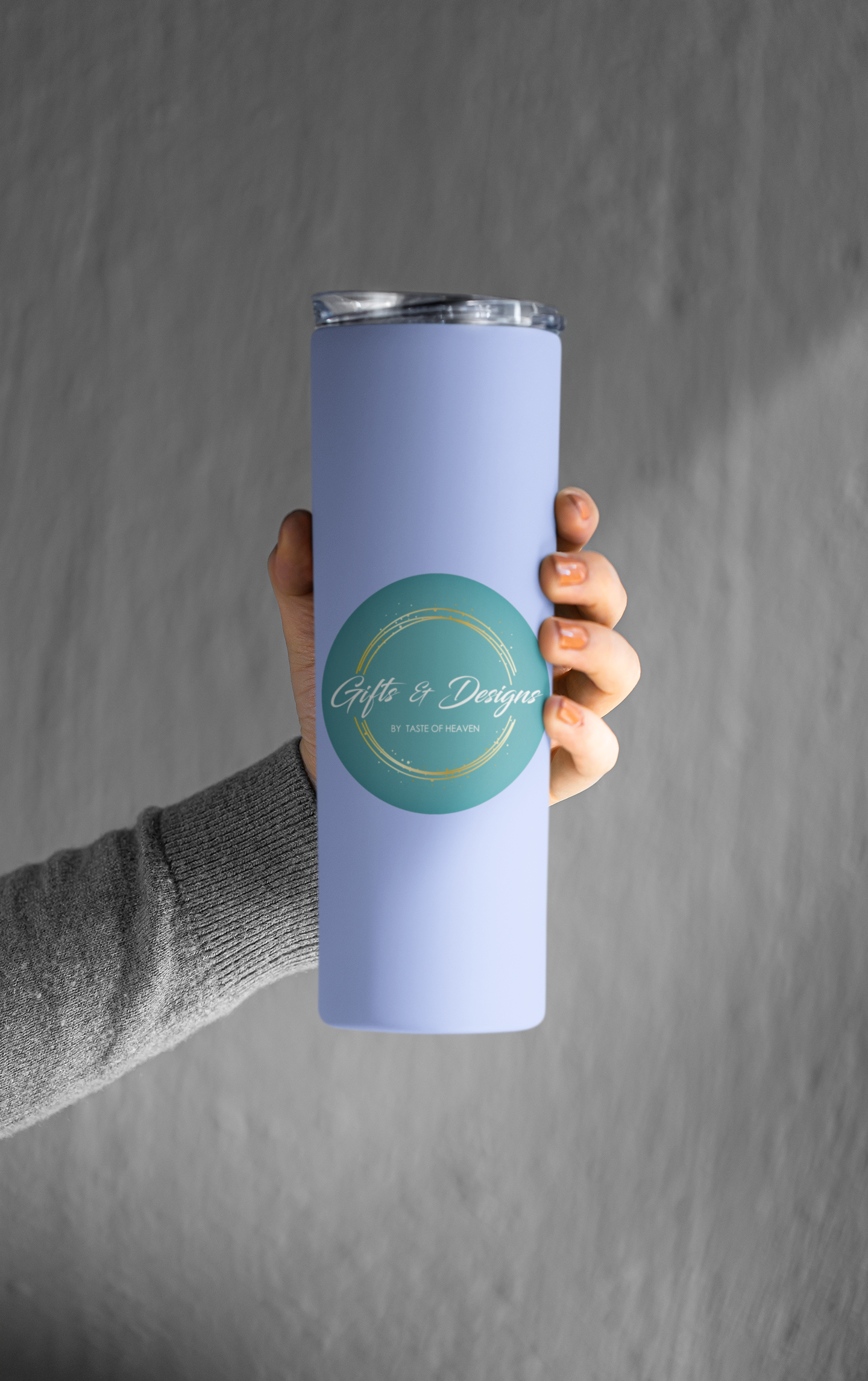 mockup-featuring-a-woman-s-hand-holding-a-skinny-tumbler-against-a-grey-wall-m21471